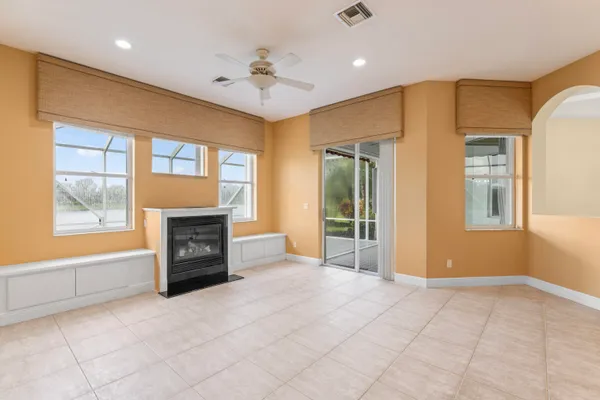 a view of an empty room with a fireplace and a window