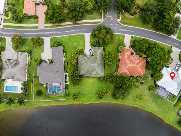 an aerial view of residential houses with outdoor space and parking