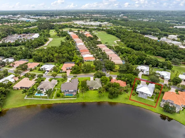 an aerial view of residential houses with outdoor space and river