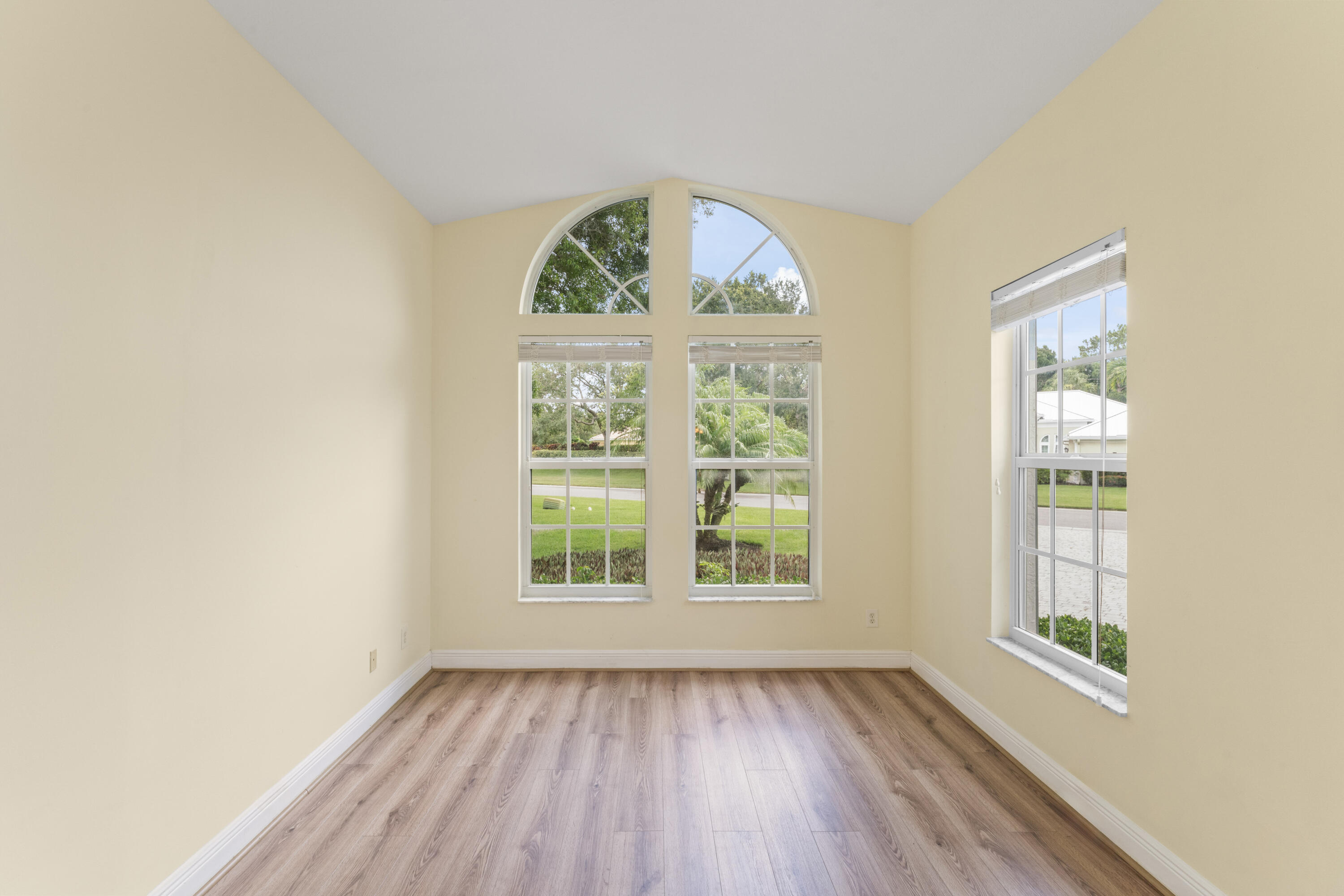 918 Southwest Blue Stem Way Stuart, FL 34997 - Photo 6 of 47 an empty room with wooden floor and windows