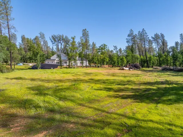 a view of a large swimming pool with an outdoor space and seating area