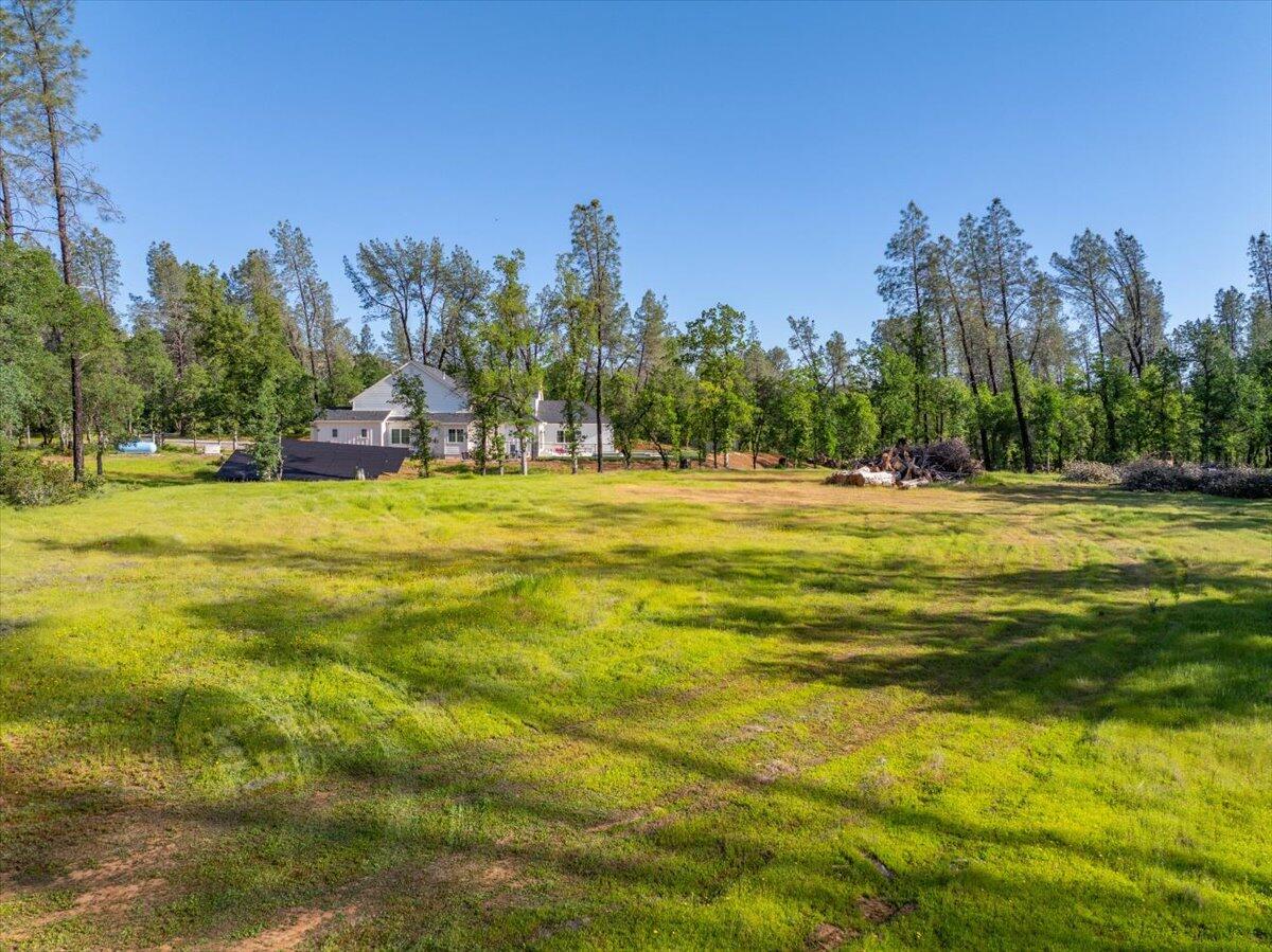 3 Silver King Road Redding, CA 96001 - Photo 5 of 13 a view of a large swimming pool with an outdoor space and seating area