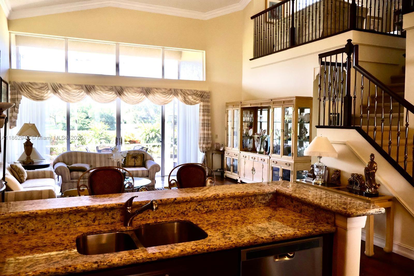 17246 Boca Club Boulevard, Unit 102 Boca Raton, FL 33487 - Photo 1 of 50 a view of a kitchen counter top a stove and a large window