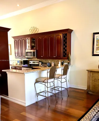 a kitchen with a table chairs and wooden floor