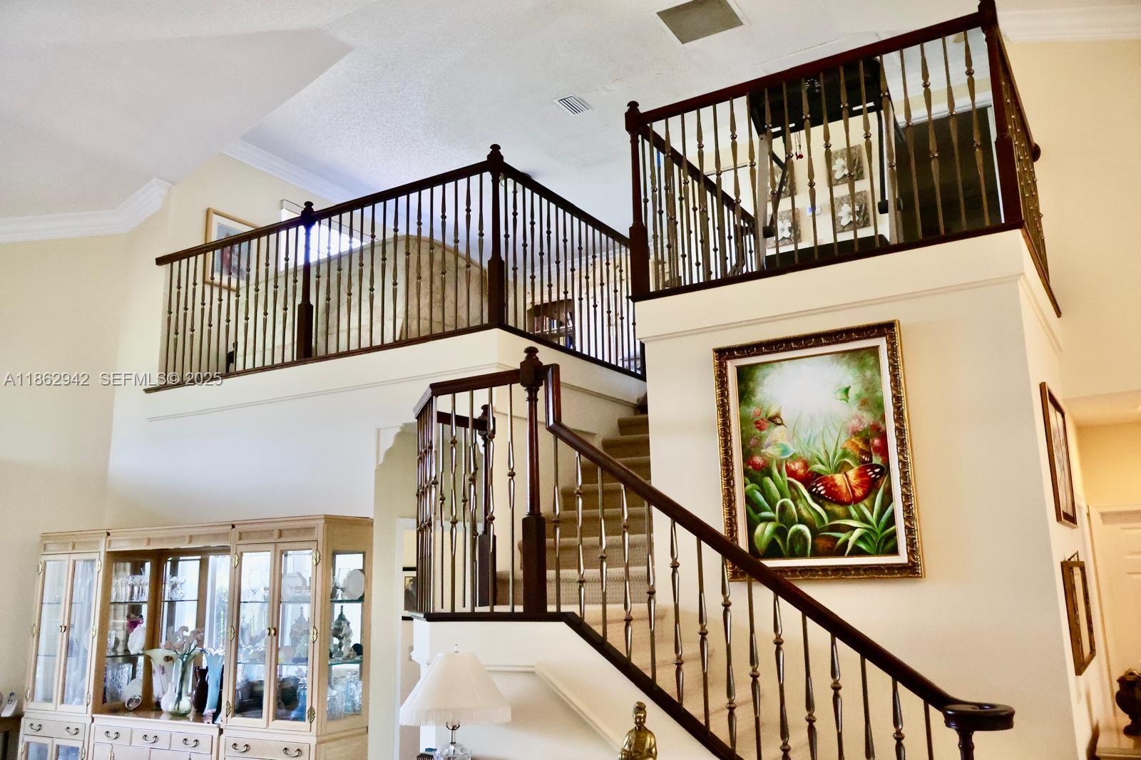 17246 Boca Club Boulevard, Unit 102 Boca Raton, FL 33487 - Photo 14 of 50 a view of staircase with lots of frames on wall