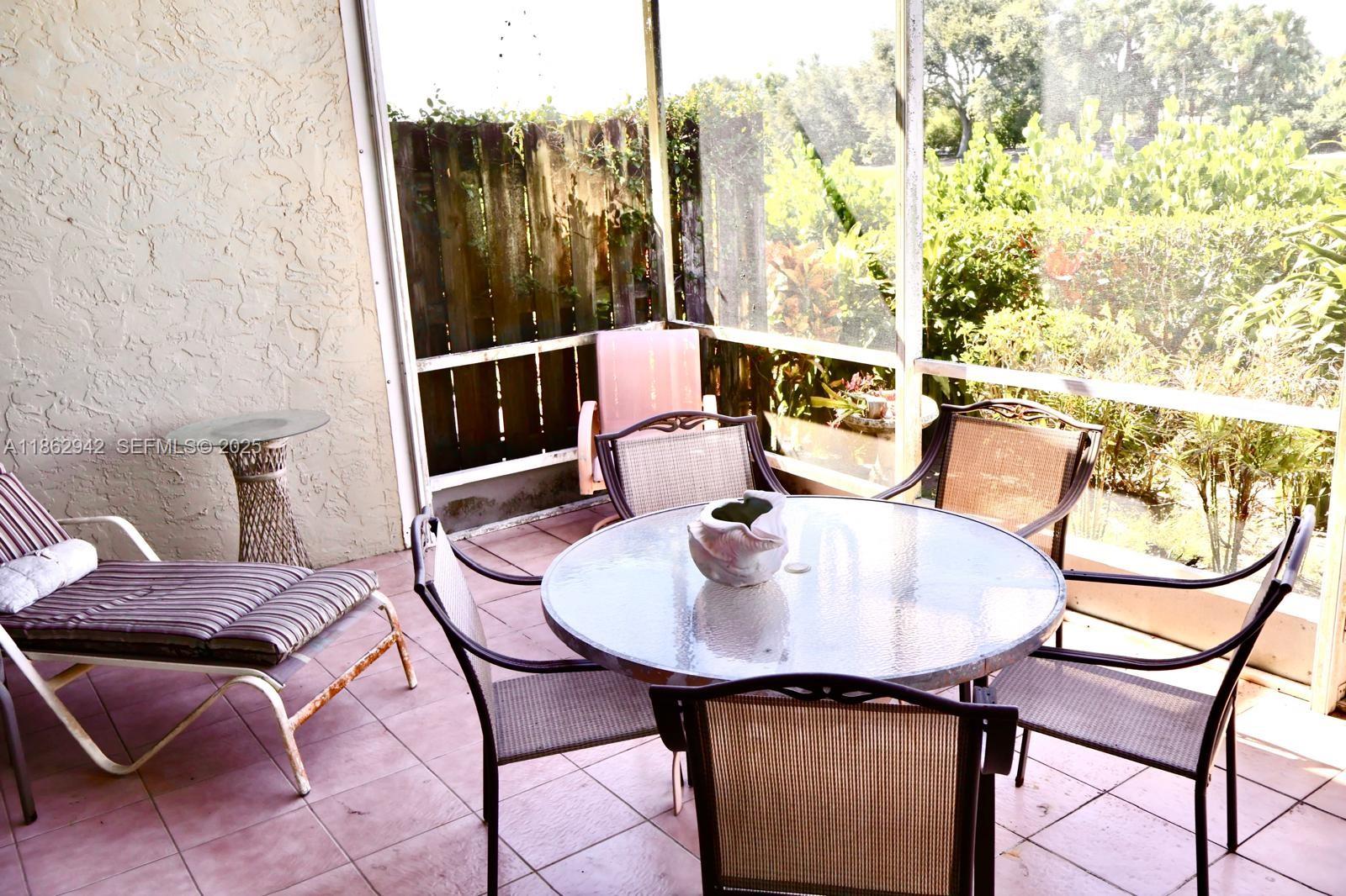 17246 Boca Club Boulevard, Unit 102 Boca Raton, FL 33487 - Photo 18 of 50 a balcony with table and chairs
