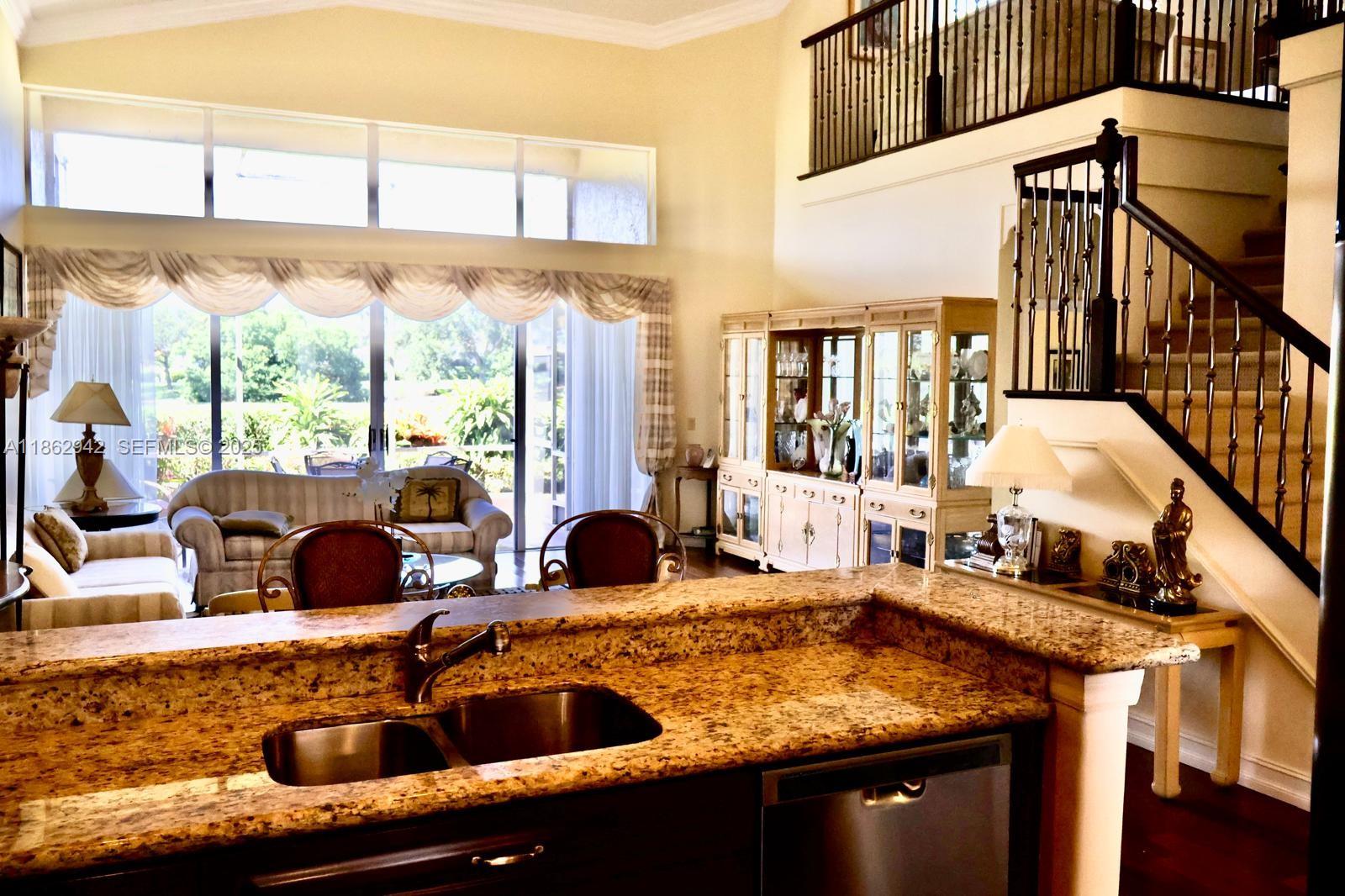 17246 Boca Club Boulevard, Unit 102 Boca Raton, FL 33487 - Photo 19 of 50 a view of living room with furniture and floor to ceiling windows