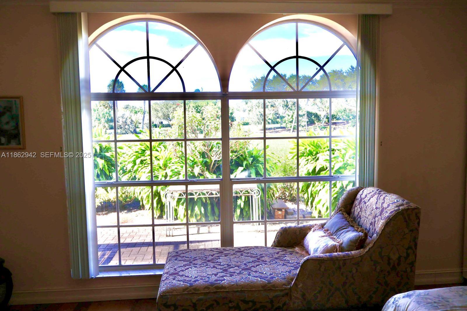 17246 Boca Club Boulevard, Unit 102 Boca Raton, FL 33487 - Photo 2 of 50 a living room with a large window and a bed