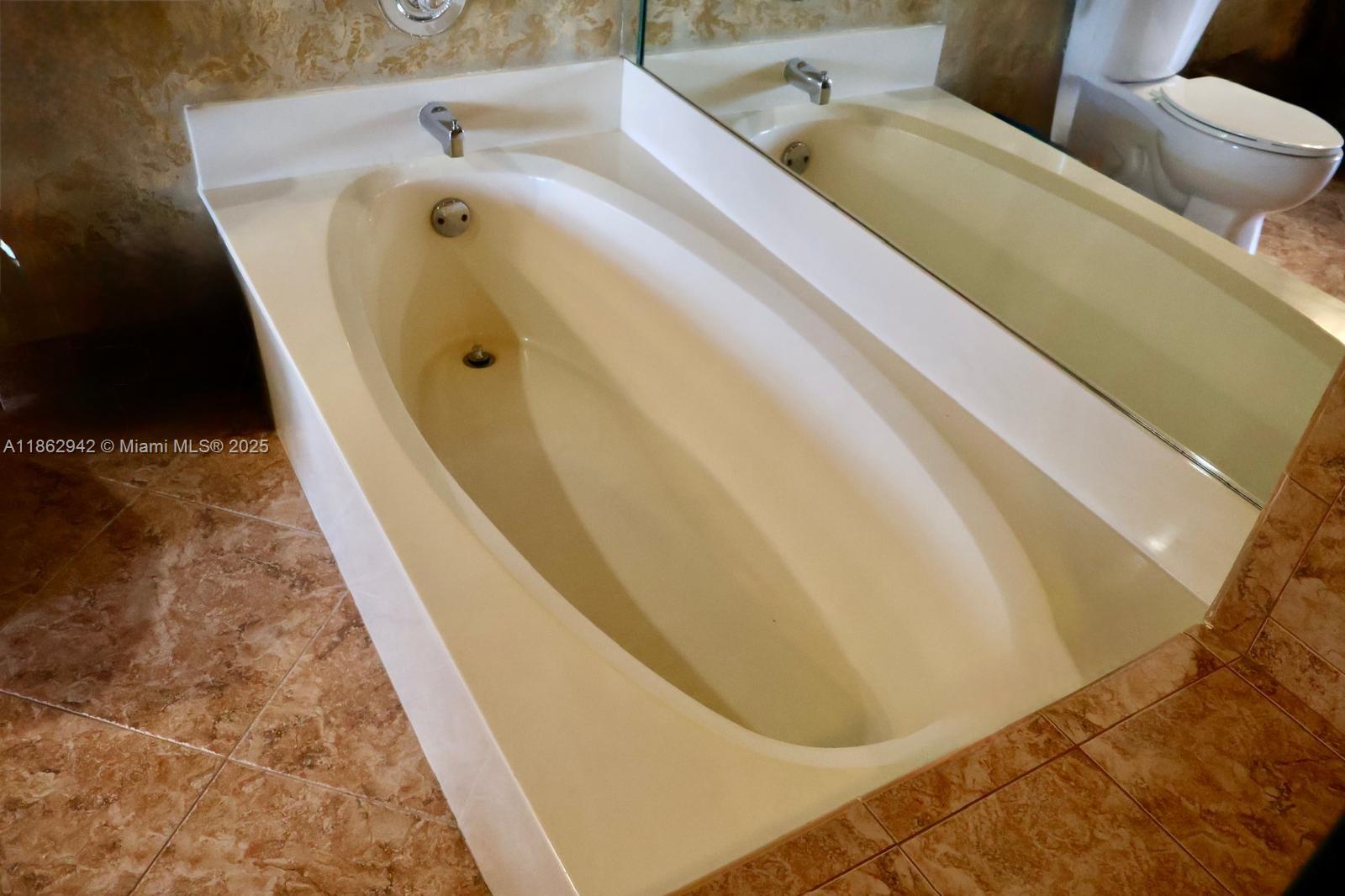 17246 Boca Club Boulevard, Unit 102 Boca Raton, FL 33487 - Photo 26 of 50 a bathroom with a bathtub