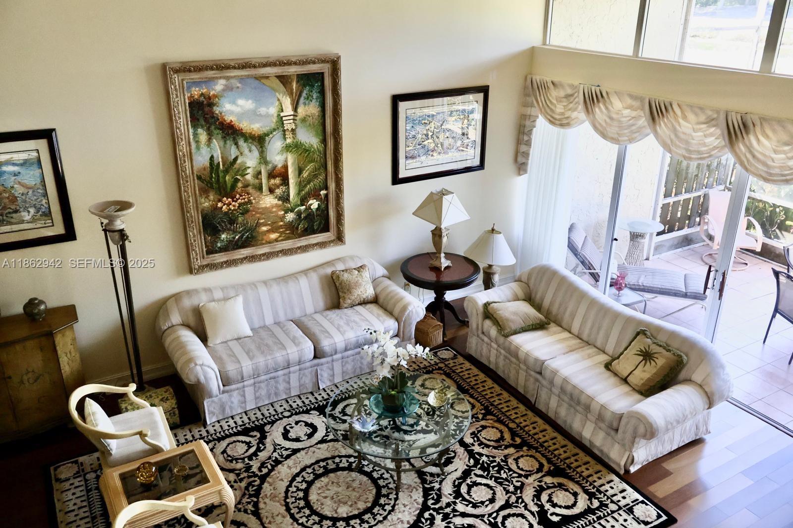 17246 Boca Club Boulevard, Unit 102 Boca Raton, FL 33487 - Photo 29 of 50 a living room with furniture and a wooden floor