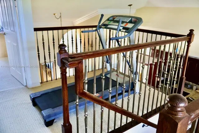 a view of staircase with wooden floor and furniture
