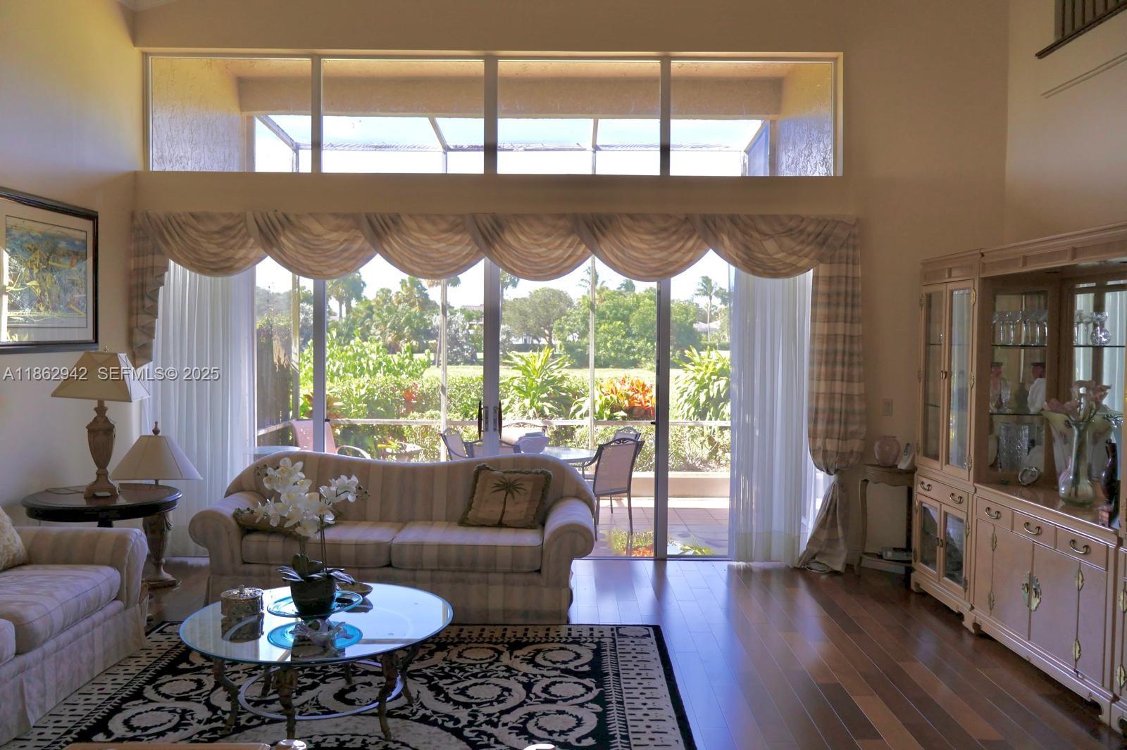 17246 Boca Club Boulevard, Unit 102 Boca Raton, FL 33487 - Photo 3 of 50 a living room with furniture and a large window