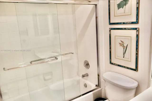 a bathroom with a shower curtain and a toilet