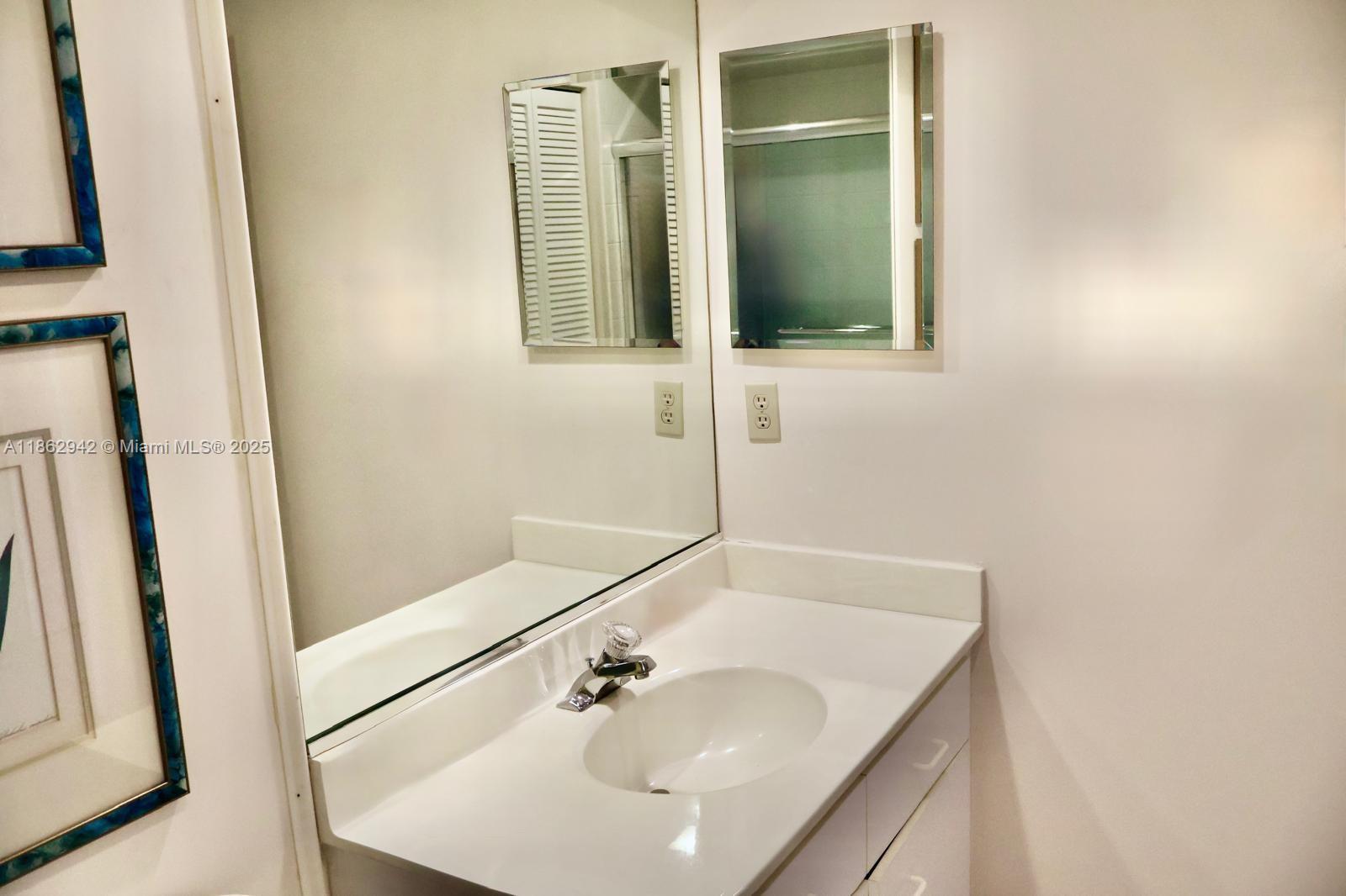 17246 Boca Club Boulevard, Unit 102 Boca Raton, FL 33487 - Photo 36 of 50 a bathroom with a sink and a mirror