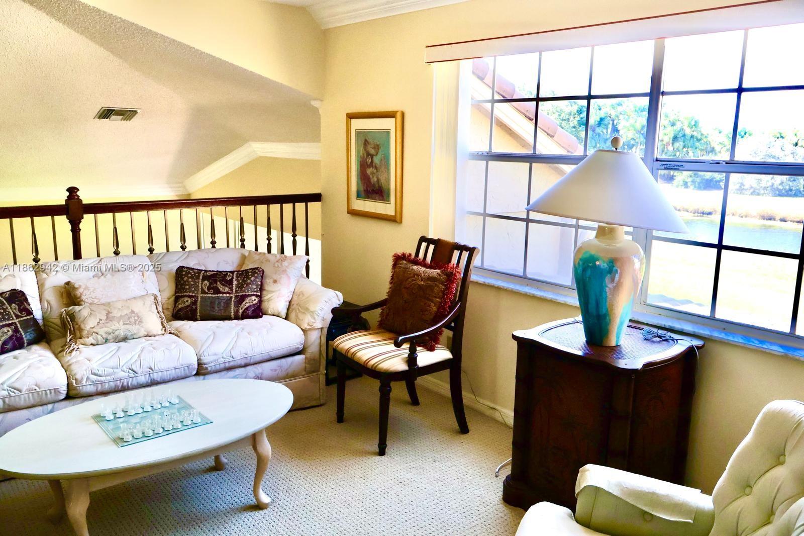 17246 Boca Club Boulevard, Unit 102 Boca Raton, FL 33487 - Photo 38 of 50 a living room with furniture and a window