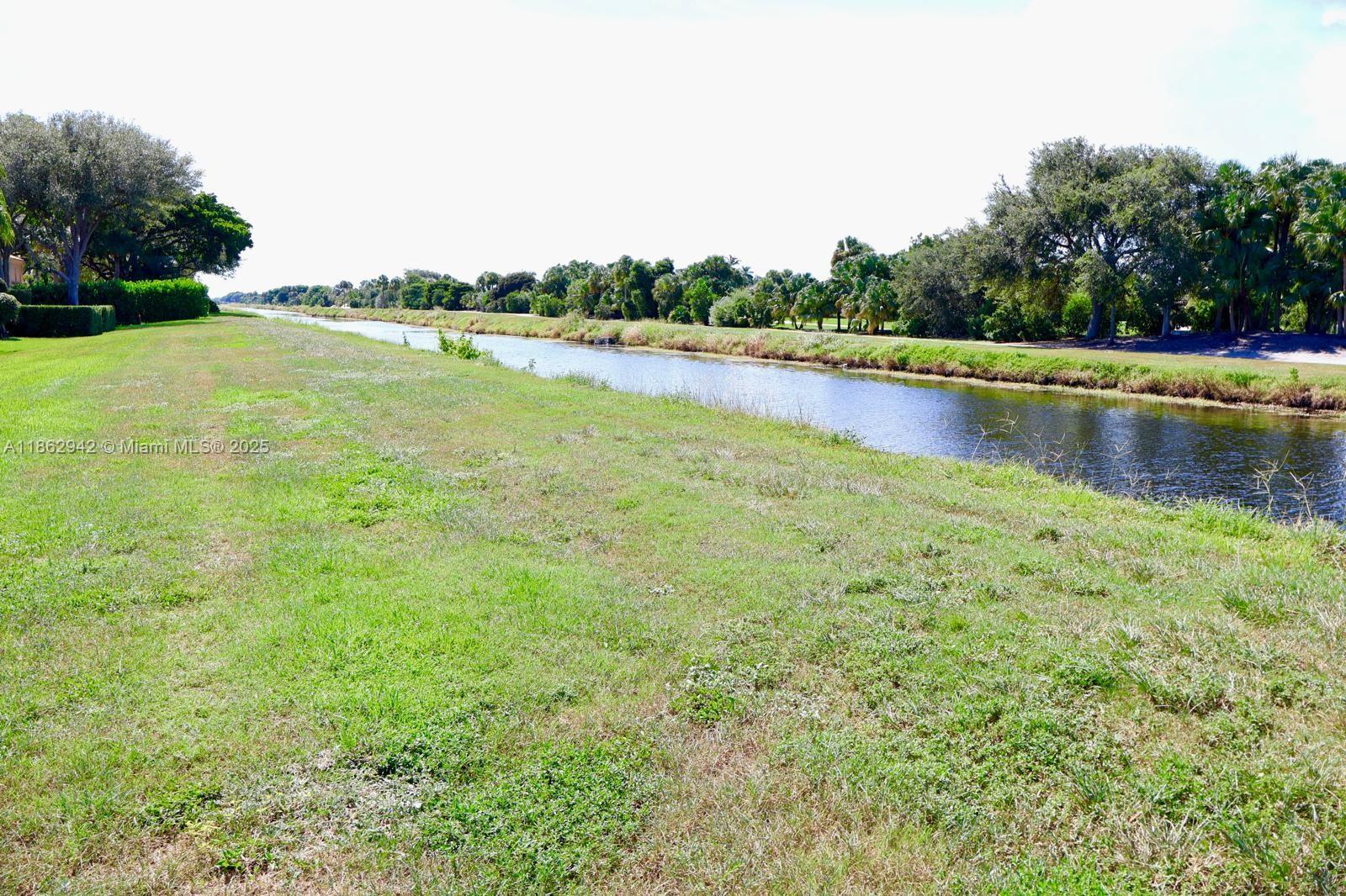 17246 Boca Club Boulevard, Unit 102 Boca Raton, FL 33487 - Photo 39 of 50 a view of a lake with houses in the back