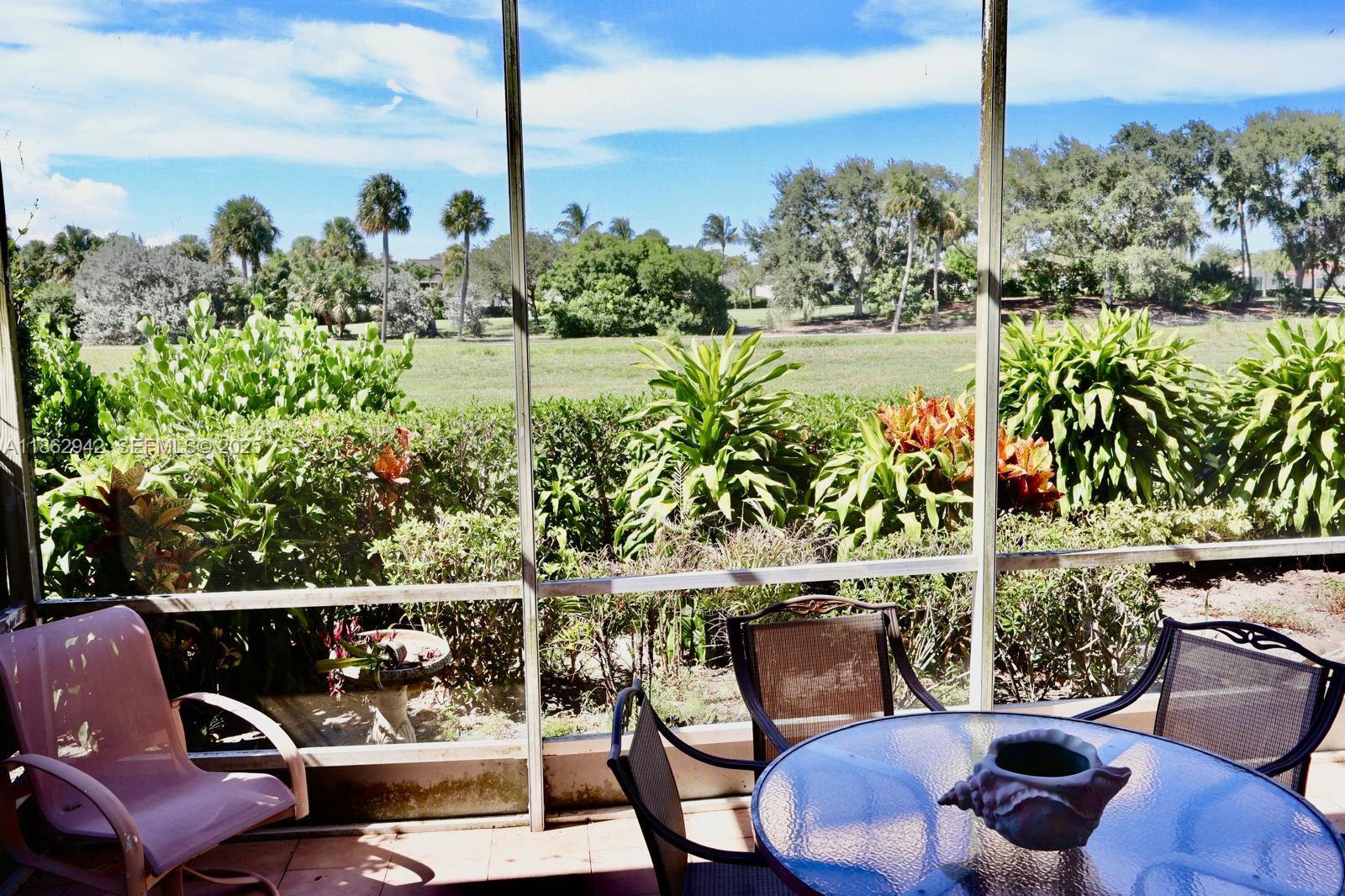 17246 Boca Club Boulevard, Unit 102 Boca Raton, FL 33487 - Photo 43 of 50 a view of a chairs and table in the patio