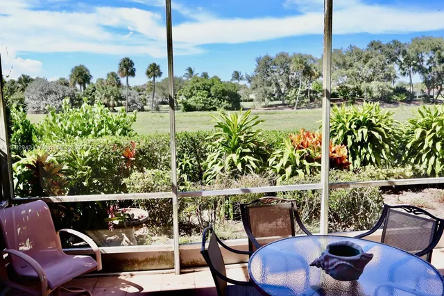 a view of a chairs and table in the patio