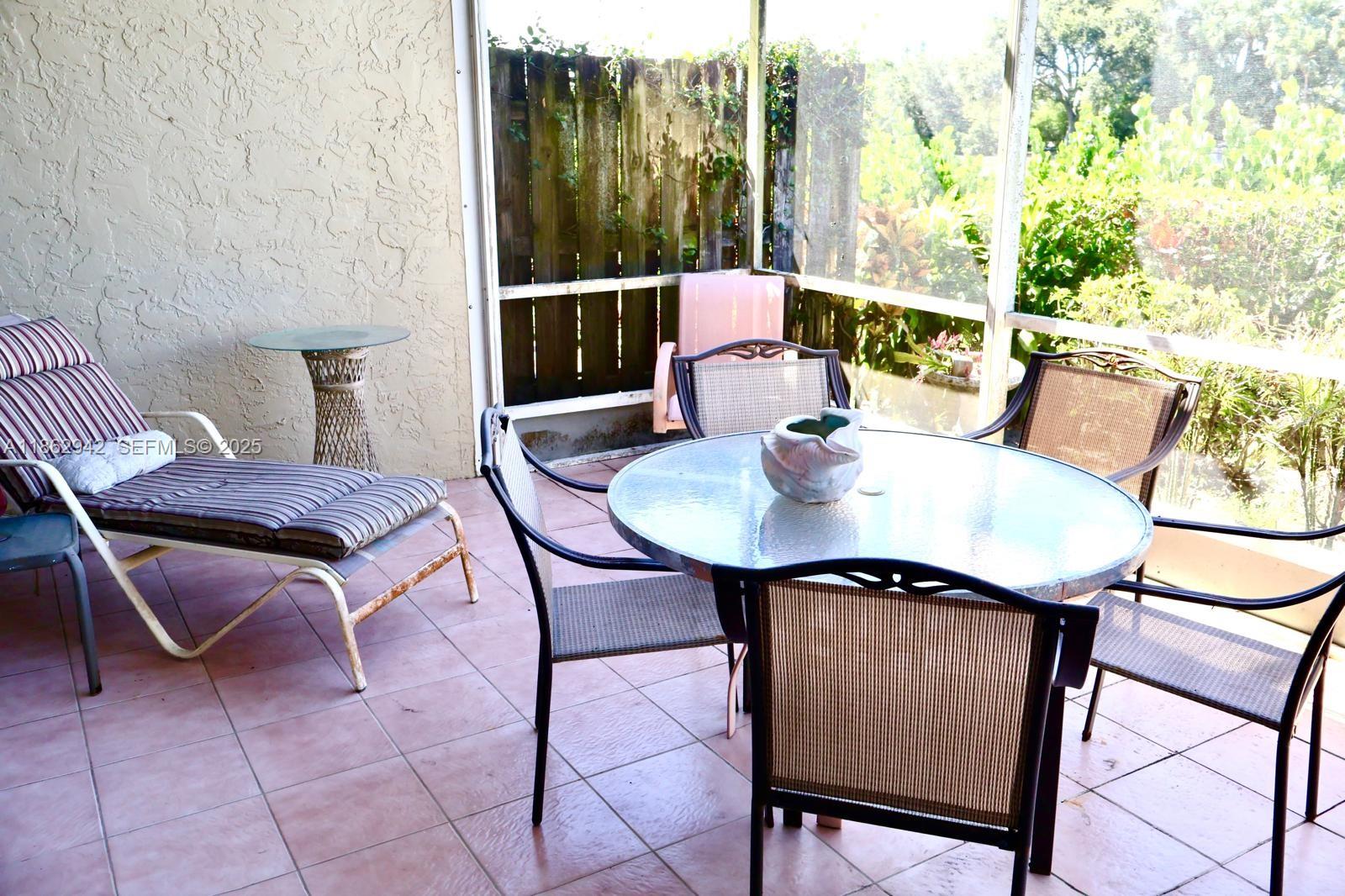 17246 Boca Club Boulevard, Unit 102 Boca Raton, FL 33487 - Photo 45 of 50 a view of a balcony dining area with furniture