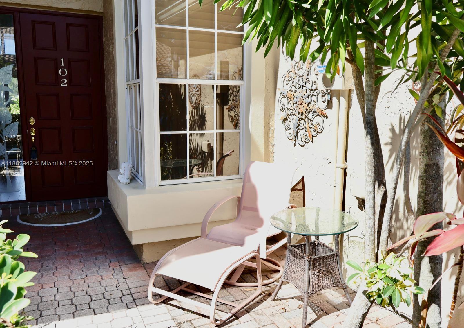 17246 Boca Club Boulevard, Unit 102 Boca Raton, FL 33487 - Photo 48 of 50 a view of a chairs and table in backyard