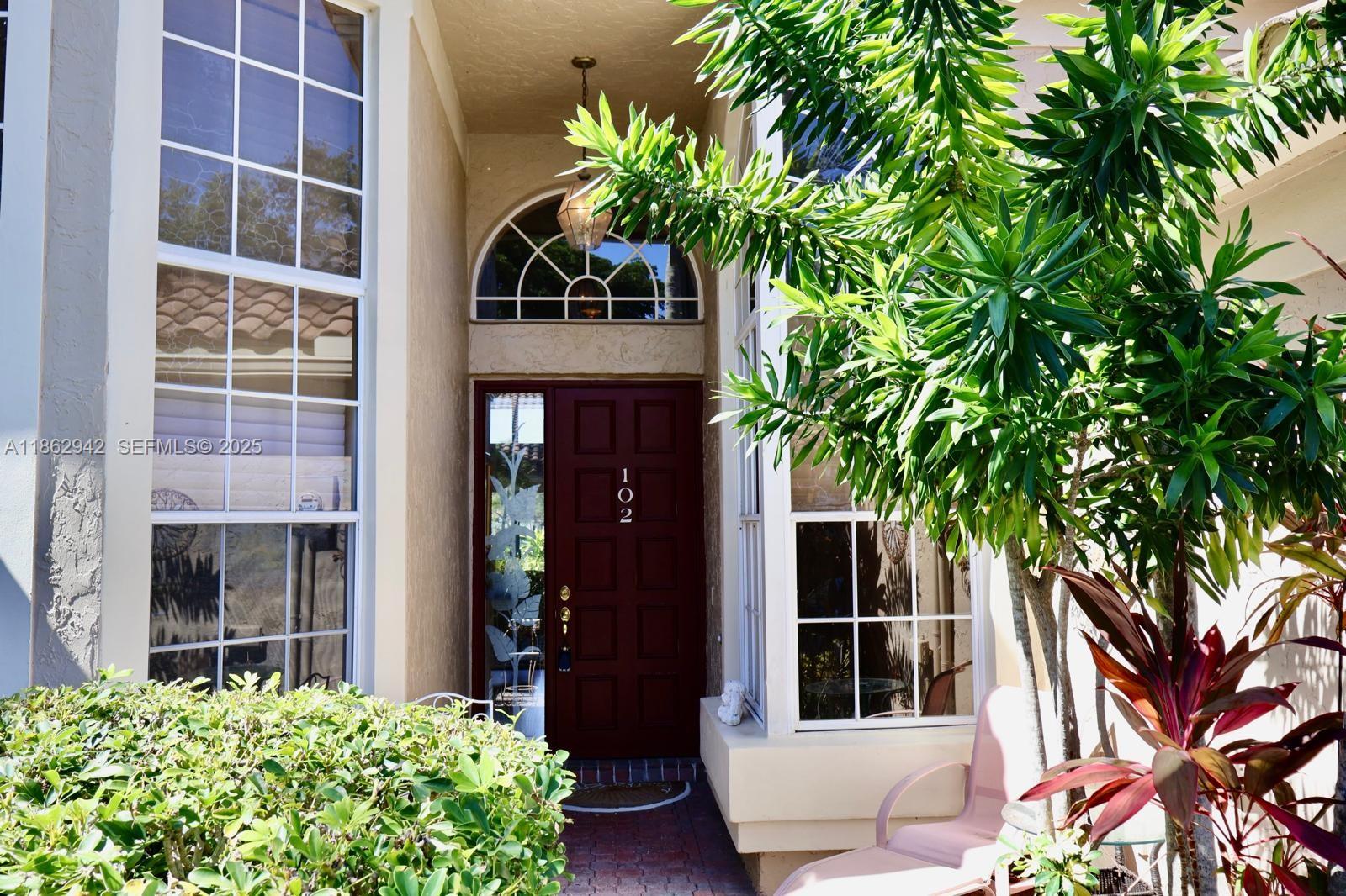 17246 Boca Club Boulevard, Unit 102 Boca Raton, FL 33487 - Photo 49 of 50 a house with a tree in front of it