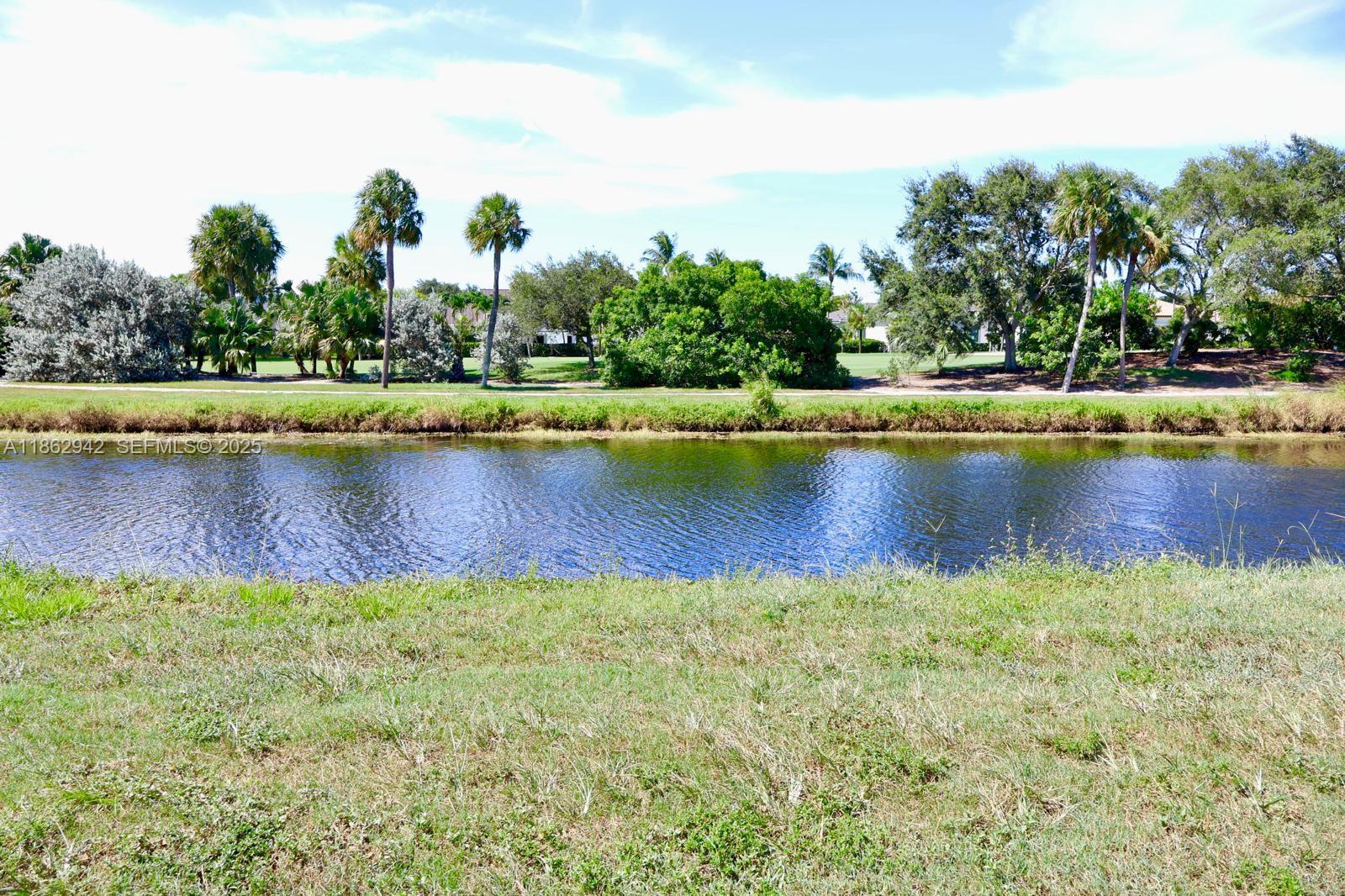 17246 Boca Club Boulevard, Unit 102 Boca Raton, FL 33487 - Photo 5 of 50 a view of a swimming pool and trees in the background