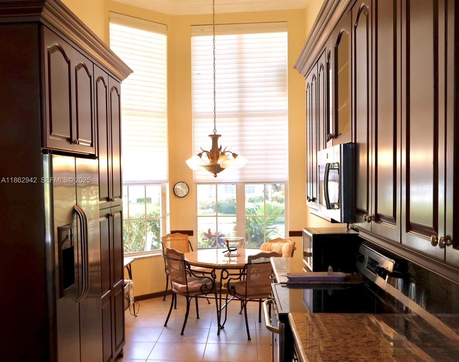 17246 Boca Club Boulevard, Unit 102 Boca Raton, FL 33487 - Photo 7 of 50 a view of a dining room with furniture and a window
