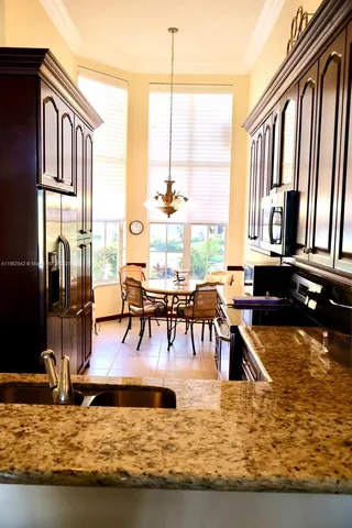 a living room with table chairs and a flat screen tv