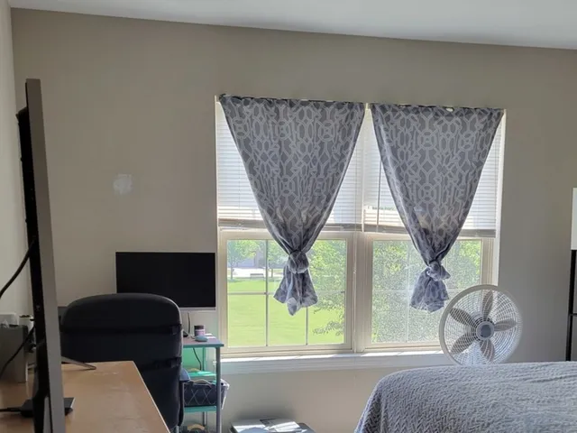 a bedroom with a bed and a window