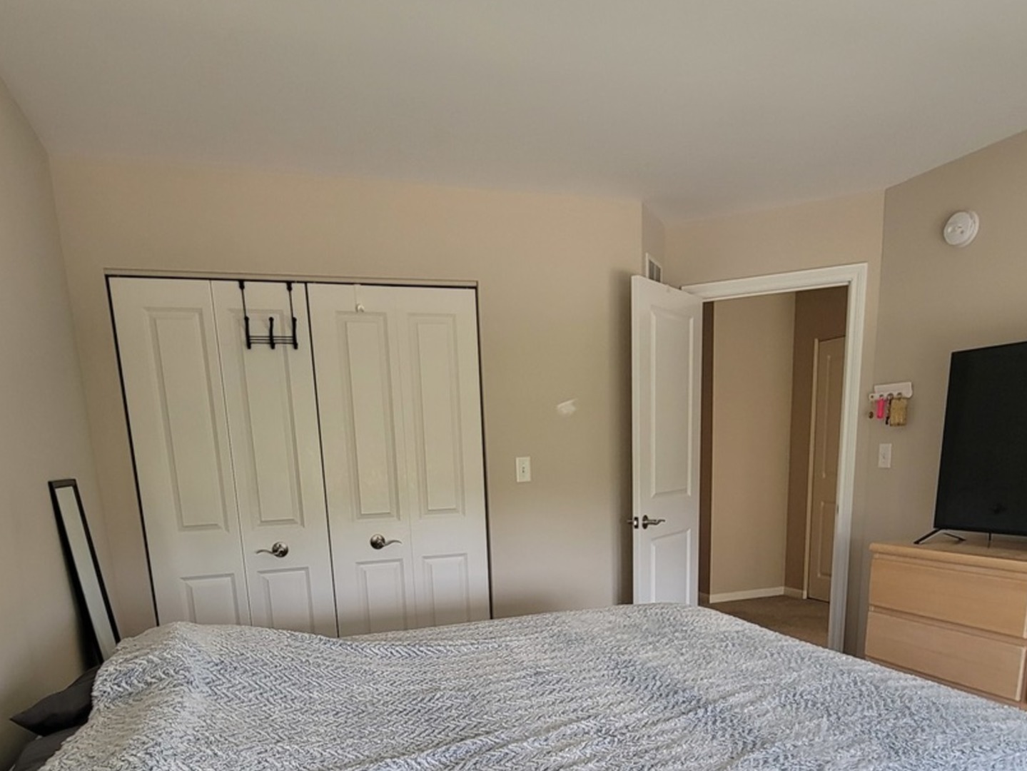 2475 Waterbury Lane Buffalo Grove, IL 60089 - Photo 14 of 19 a bedroom with a bed and a flat screen tv