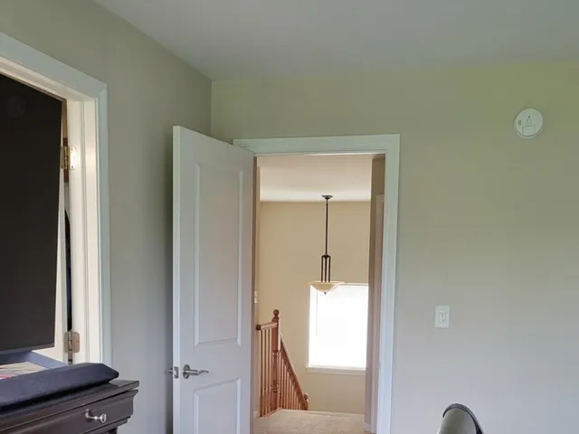 a view of a hallway with a mirror and a window