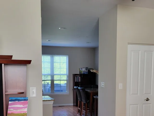 a view of a workspace with furniture and a window