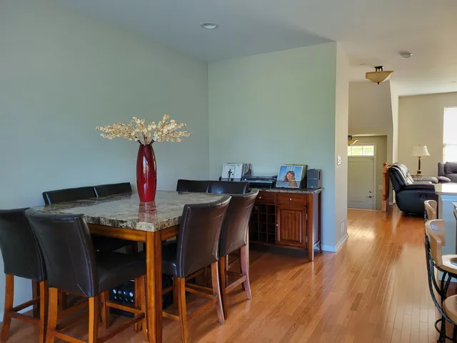 a dining room with furniture and wooden floor