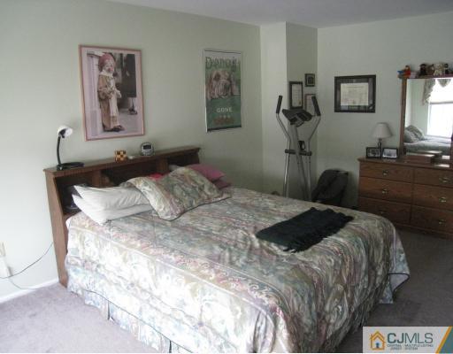 1419 Plymouth Road North Brunswick, NJ 08902 - Photo 7 of 9 a bedroom with a bed and a chandelier
