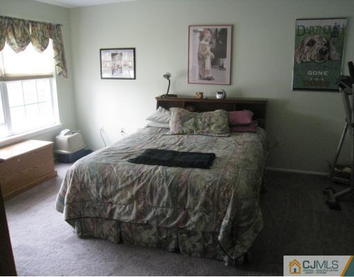 1419 Plymouth Road North Brunswick, NJ 08902 - Photo 8 of 9 a bedroom with a bed and a window