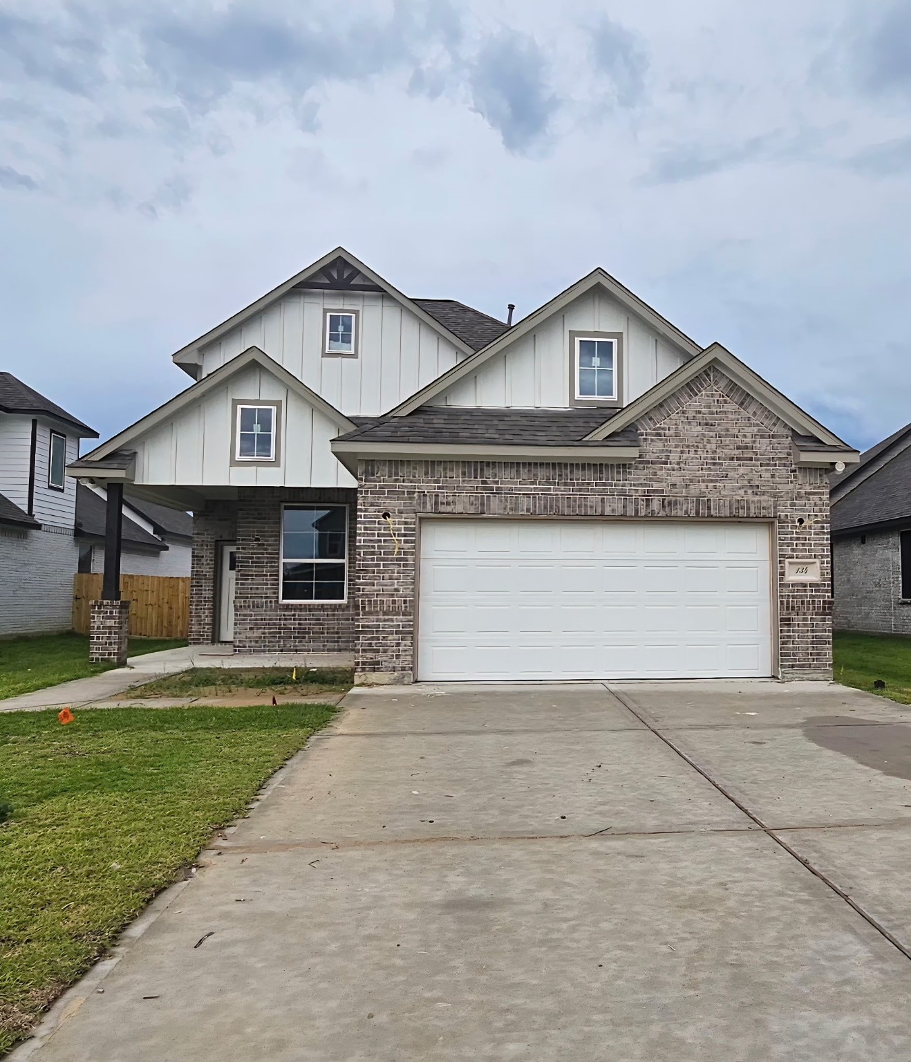 134 Peachleaf Court Anahuac, TX 77514 - Photo 2 of 7 a front view of a house with a yard and garage