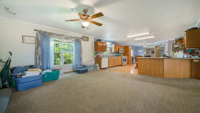 a large kitchen with stainless steel appliances a large counter top