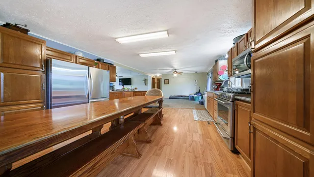 a view of a livingroom with a ceiling fan and window
