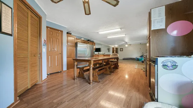 a big room with windows and chandelier fan