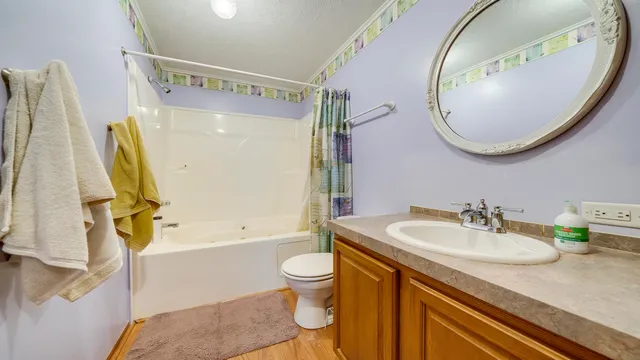 a bathroom with a shower curtain and a sink