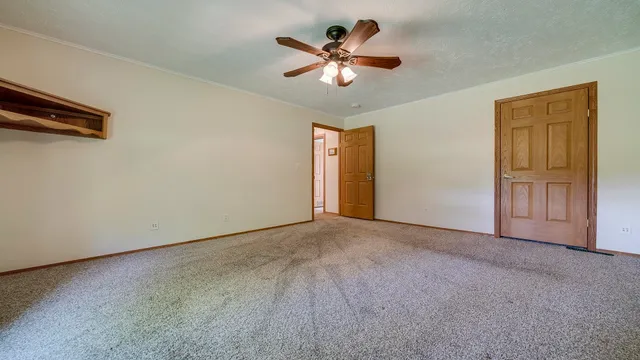 a living room with furniture and a ceiling fan
