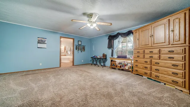 a bed room with a bed and a chair