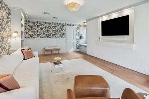 a living room with furniture and a chandelier