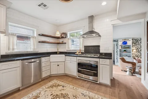 a dining room with furniture a chandelier and wooden floor