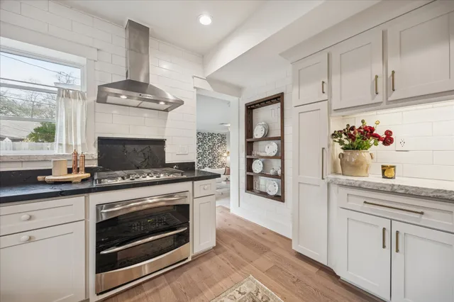 a kitchen with granite countertop a refrigerator and a sink
