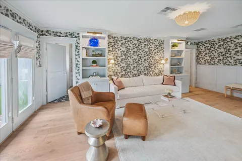 a kitchen with stainless steel appliances a stove and white cabinets