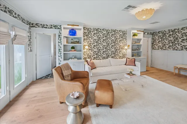 a kitchen with stainless steel appliances a stove and white cabinets