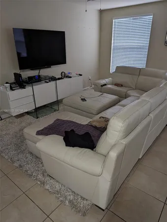 a bedroom with a bed a dresser and book shelf