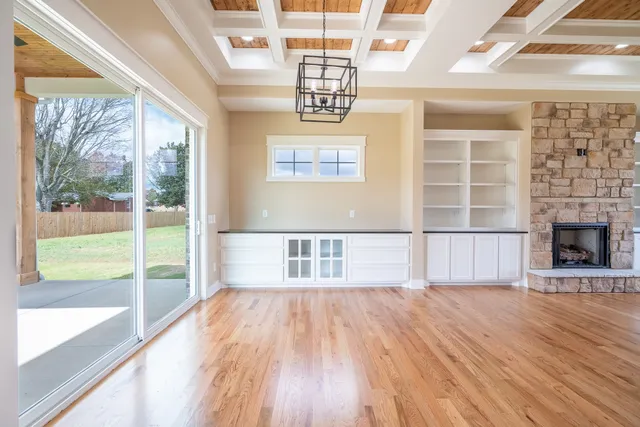 a kitchen with a sink stove and wooden floor