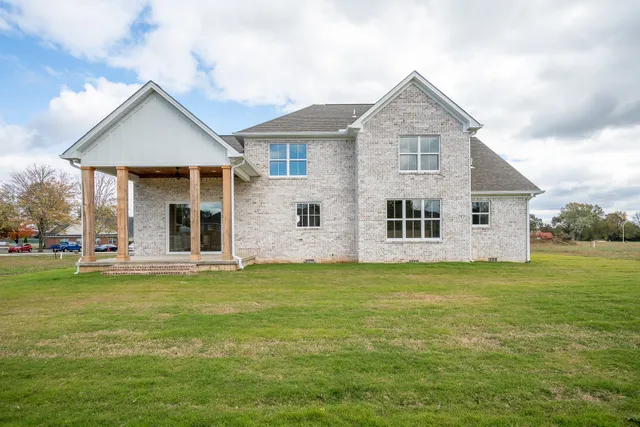 a front view of a house with a garden